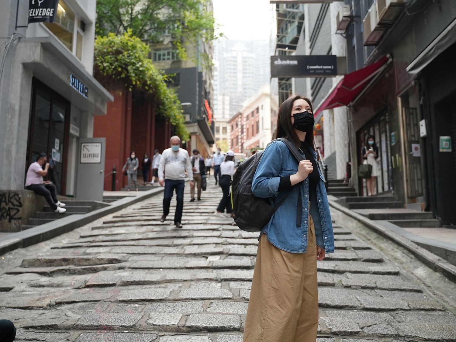 Melody Cheng walks the streets of Hong Kong using the Dyson Air Quality Backpack.